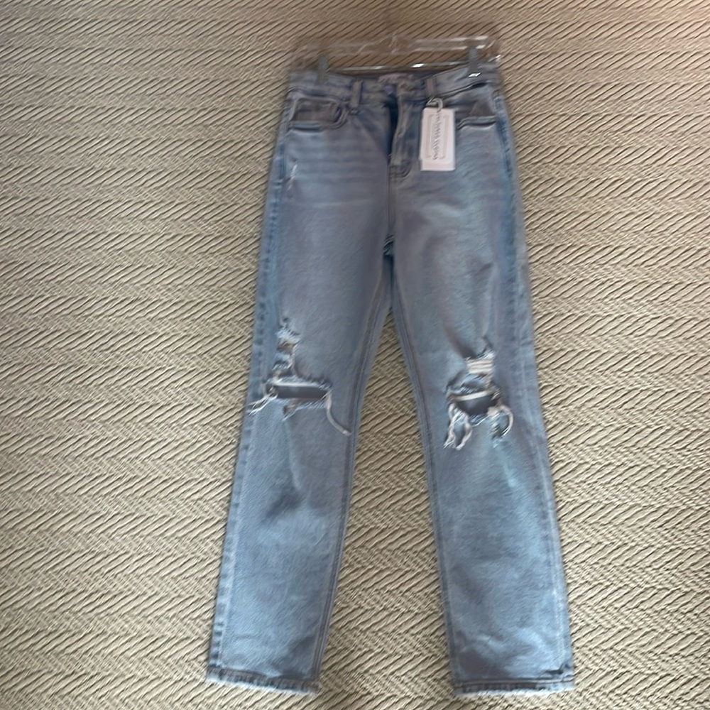 never worn still has tags light washed blue jeans loose bottoms